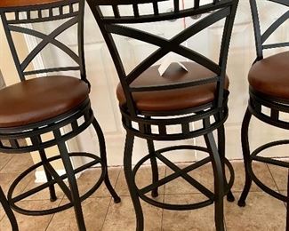 Lot 8286.$120.00 3 metal frame swivel bar stools from, 300 lb max.weight load, wood accent on back with faux brown leather seats. 45"t x 29" seat height x 18" dia