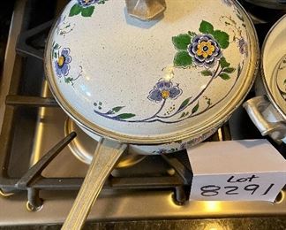 Lot 8291. $95.00. 1851 ASTA German Enamel Cookware, 7 pc. 10" fry pan w/lid, 10" dia dutch oven w/lid, 2 double handled pans, 8"dia x 2.5"t pan (no lid), 8" dia x 5"T pan (no lid), 6.5" lid - no pan. Purple, gold, green floral patterns.