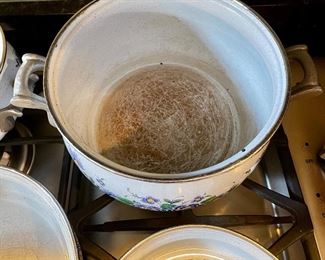Lot 8291. $95.00. 1851 ASTA German Enamel Cookware, 7 pc. 10" fry pan w/lid, 10" dia dutch oven w/lid, 2 double handled pans, 8"dia x 2.5"t pan (no lid), 8" dia x 5"T pan (no lid), 6.5" lid - no pan. Purple, gold, green floral patterns.
