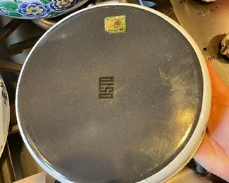 Lot 8291. $95.00. 1851 ASTA German Enamel Cookware, 7 pc. 10" fry pan w/lid, 10" dia dutch oven w/lid, 2 double handled pans, 8"dia x 2.5"t pan (no lid), 8" dia x 5"T pan (no lid), 6.5" lid - no pan. Purple, gold, green floral patterns.