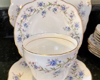 Lot 8293. $65.00 Ducchess bone china "Tranquility" Pattern, partial luncheon/tea set. 5 cups, 6 saucer, 6 square plates, 1 serving plate and a creamer. 19pc.