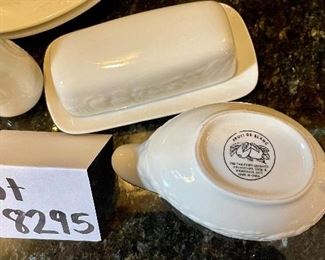 Lot 8295. $75.00. 10 pc. of White Fruits de blanc dinnerware serving pieces, featuring fruit decor in relief on all pieces, includes: 14" oval platter, covered butter dish, creamer, sugar, salt and pepper, gravy/saucer, 2 dinner plates or cookie plates, and a white Kaiser tankard or pitcher 9.5" T.