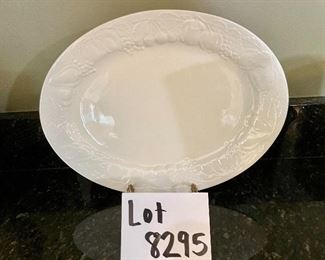Lot 8295. $75.00. 10 pc. of White Fruits de blanc dinnerware serving pieces, featuring fruit decor in relief on all pieces, includes: 14" oval platter, covered butter dish, creamer, sugar, salt and pepper, gravy/saucer, 2 dinner plates or cookie plates, and a white Kaiser tankard or pitcher 9.5" T.