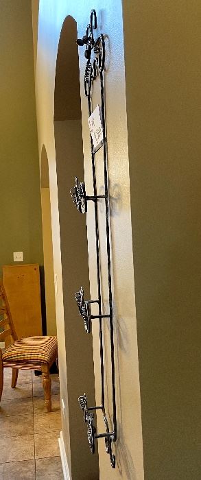 Lot 8300. Pewter look 3 plate rack with grape designs. 36" L x 8" W.