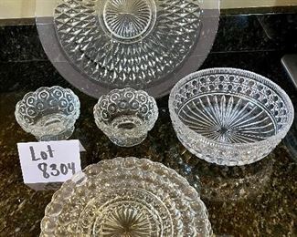 Lot 8304. $26.00 Lot of vintage glass serving pieces: 3- 9" plates with a bubble look; 2 small pedestal bowls; a large serving bowl (8.5" x 3"T); and a large 15" glass platter.