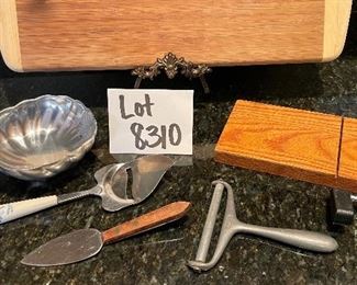 Lot 8310. $27.00 Lot of appetizer items. Bamboo cutting board (great for charcuterie too) 18" x 12"; cheese plane, cheese slicer, spreader, guillotine cheese slicer and an Armatelle dip bowl.
