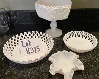 Lot 8315. $40.00. Vintage milk glass items: 9" lattice trim milk glass dish; 1 small reticulated milk glass bowl; a 6' ruffled edge milk glass bowl (note small chips on one edge); and a lovely milk glass pedestal bowl with interesting pattern, 7.5" diam x 8" T.