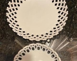 Lot 8315. $40.00. Vintage milk glass items: 9" lattice trim milk glass dish; 1 small reticulated milk glass bowl; a 6' ruffled edge milk glass bowl (note small chips on one edge); and a lovely milk glass pedestal bowl with interesting pattern, 7.5" diam x 8" T.