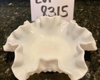 Lot 8315. $40.00. Vintage milk glass items: 9" lattice trim milk glass dish; 1 small reticulated milk glass bowl; a 6' ruffled edge milk glass bowl (note small chips on one edge); and a lovely milk glass pedestal bowl with interesting pattern, 7.5" diam x 8" T.