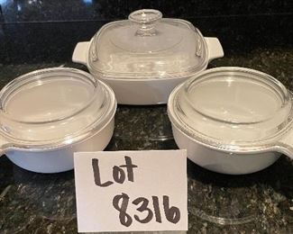 Lot 8316. $20.00 3Pc. Lot includes: Two Corning Grab-it handled bowls with glass lids (150-B) and 1 7" sq baking dish with glass lid (A-1-B).