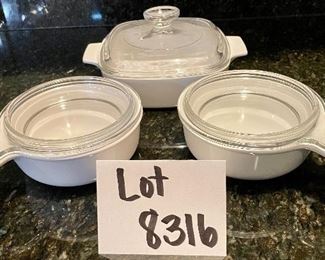 Lot 8316. $20.00 3Pc. Lot includes: Two Corning Grab-it handled bowls with glass lids (150-B) and 1 7" sq baking dish with glass lid (A-1-B).