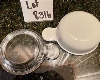 Lot 8316. $20.00 3Pc. Lot includes: Two Corning Grab-it handled bowls with glass lids (150-B) and 1 7" sq baking dish with glass lid (A-1-B).