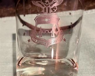 Lot 8323. $60.00 "Off we go into the Wild Blue Yonder...." a set of 8 silver rimmed Air Force Academy low-ball glasses and Stalag Luft pitcher with glass stirrer and a single low-ball glass.