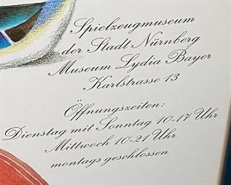 Lot 8334. $40.00 Set of 2 colorful Spielzeug Museum posters, framed in a blue frame.