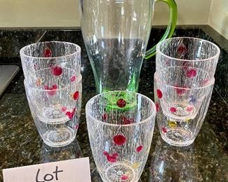 Lot 8340. $20.00 An 11" green plastic pitcher with lid (BPA free) and 5 cute Disney glasses in as is condition (not dishwasher safe!)