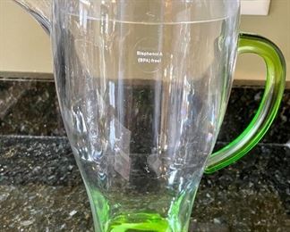 Lot 8340. $20.00 An 11" green plastic pitcher with lid (BPA free) and 5 cute Disney glasses in as is condition (not dishwasher safe!)