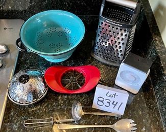 ot 8341. $38.00. Kitchen collection: Kitchen Aid Gourmet 4 sided box grater; turquoise 9" metal colander -made in Poland; red, Good Cook apple cutter; steamer basket' vegetable peeler; serving spoon and fork and a small scale.