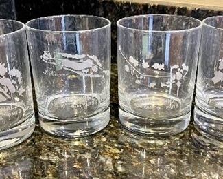 Lot 8349. $35.00. Golf beverage assortment including 5 Jason vintage golf scene placemats, 4 Old Fashioned glasses, each with an etched design of different courses - Augusta, Pinehurst, Firestone & Doral- with hole stats; 2 golf themed cups and 2 golf themed tumblers.