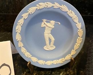 Lot 8350. $45.00. Black Watch plaid golf hat (tam) from Ghillie Products Scotland featuring Glen Eagles, St. Andrews, Muirfield and Turnberry on the front of the hat. Also included are a miniature golf bag clock and a Jasperware golf themed mini plate.