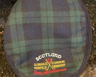 Lot 8350. $45.00. Black Watch plaid golf hat (tam) from Ghillie Products Scotland featuring Glen Eagles, St. Andrews, Muirfield and Turnberry on the front of the hat. Also included are a miniature golf bag clock and a Jasperware golf themed mini plate.