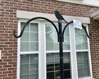 Lot 8358. $70.00 Wild Birds Unlimited APS hanging system; 48" base pole with 48" extension pole, a double crook arm with squirrel baffle and chickadee finial. A garden centerpiece.