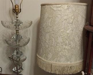 Lamp on left is crystal. Crystal pieces are packaged with some broken tips, metal brackets for hanging are busted on the crystal pieces.