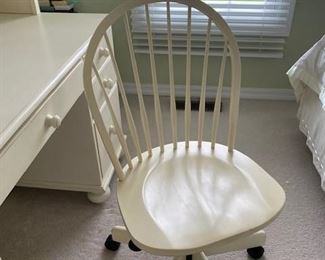 Chair has swivel base on wheels