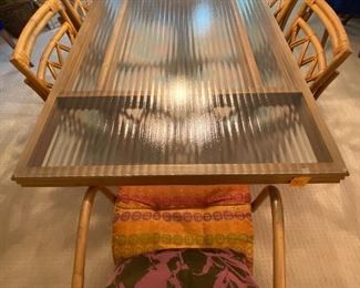 Vintage Dining room table and chairs. The table is believe to be by Ficks and Reed. However; not guaranteed as it does not have a manufacturer's marking.
The glass top on the table has one small chip in one corner. The table measures 6' x 38" x 29". Located in a walk out basement level of the home.