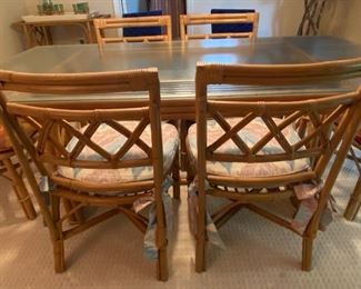 Vintage Dining room table and chairs. The table is believe to be by Ficks and Reed. However; not guaranteed as it does not have a manufacturer's marking.
The glass top on the table has one small chip in one corner. The table measures 6' x 38" x 29". Located in a walk out basement level of the home.