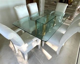Contemporary Style Dining Room Table w/ Six Upholstered Chairs in very good condition.
Table measures 6' x 42" and the chairs are 38" h.