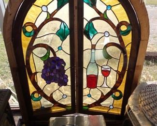 STAINED GLASS WINDOW THAT OPENS UP. SLIGHT DAMAGE ON THE WINE SIDE. $495.00