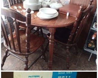*(oh-so-desirable) Tell City Chair Company dining set*
round oak table w/ 3 chairs & removable leaf