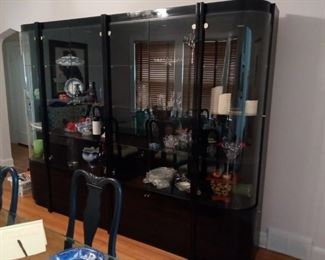 Black lacquering with chrome accents. 4 sections. 106" x 80" tall x 22" deep. Can be separated to fit your room.