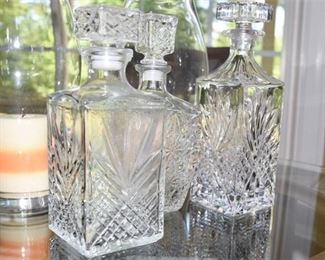 Three 3 Glass Decanters and a Pair Of Glass Candle Holders