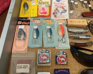 Vintage Joe camel lighters, vintage fishing tackle still in package and pocket knives.