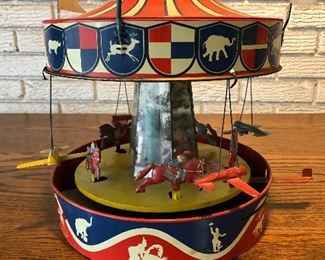 Vintage Tin Lithographed Carousel by Wolverine. Spring action / Wind up. Works great.