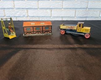(3) Vintage 1930’s German Tin Toys- all are marked made in Germany
A Truck, a building, and girl on swing