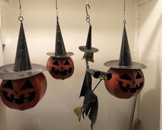 3 hanging metal pumpkins and a witch