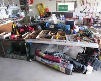 Garage is loaded with tools, tent, clam ice house, and more