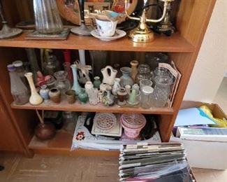 wood and glass display cabinets with glassware and vases