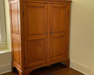 MAHOGANY TWO DOOR ARMOIRE | Antique, having a dentil molding over two doors revealing four inner shelves, all over a sculpted apron; h. 61 x 22-1/2 x 48 in.