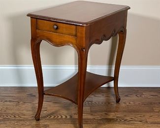 RENE TROTEL WOOD SIDE TABLE | With single drawer and bottom shelf, curved legs and wavy carved side details; side of the drawer stamped "R Trotel" for Rene Trotel of France; 30 x 25 x 17-1/2 in. 