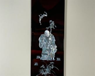 MOTHER OF PEARL PANEL | Mother of pearl applique on laquered wood depicting a Buddha figure and child in subtle mountain scene; 19 x 7-1/2 in. 