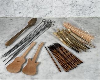 LOT OF ASSORTED UTENSILS | Nice lacquered chopsticks with mother of pearl inlays (9 in.), barbeque skewers (18 in.), tiny spoons with long handles of horn (8-1/2 in.), wooden skewers, guitar shaped salad scoopers, and a large wooden spoon (13-1/4 in.) 