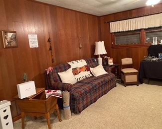 Plaid Sofa, Throw Pillows, Blanket, Goat with Plastic Cactus, End Table, Ceramic Lamp, Hand Carved Storage Container, Rock Maple End Table with Storage Area, Throw Rug, Sewing Machine Chair with Storage on Wheels