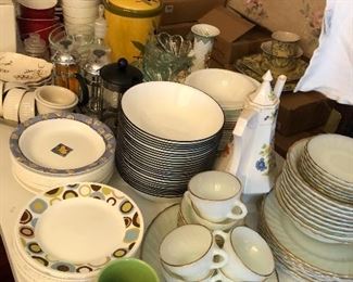 lots of Corelle bowls and plates in mixed patterns