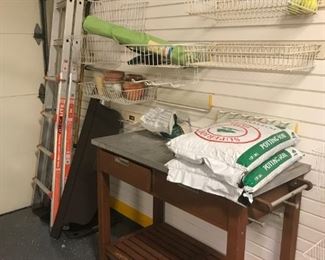 Potting table, potting soil, ladders.  Racks on wall are not available for sale.