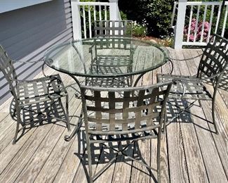 Wrought iron table with glass top & 4 armchairs 