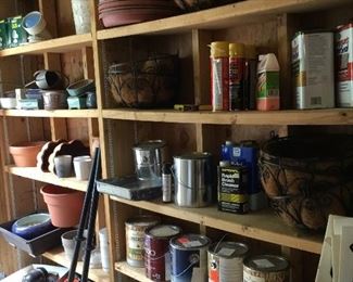 Garage shelves full, lots of Garden items 
