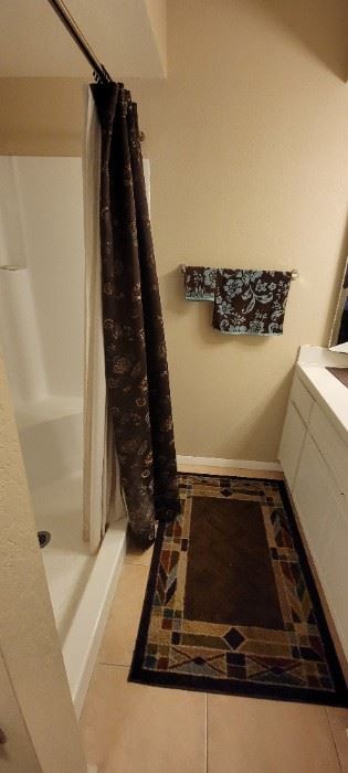Decorative bath mat and shower curtain